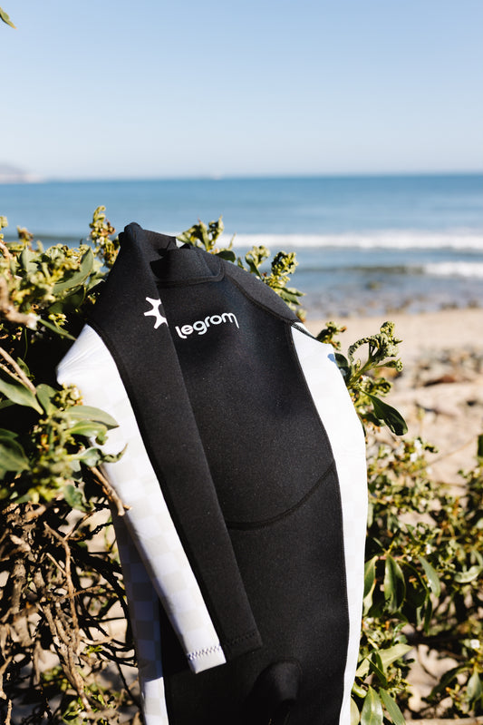 Le Grom Ash black checker toddler wetsuit product photo - full body front view with sun logo detail